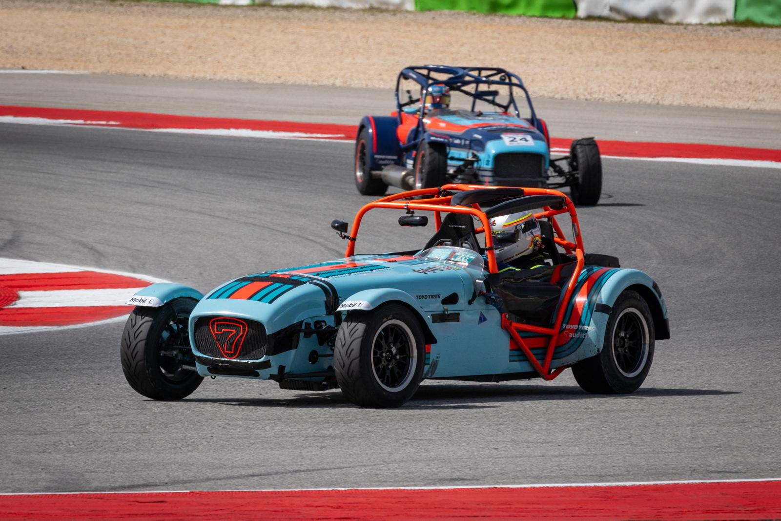 Diego Sirgado leading a Caterham wheel-to-wheel battle