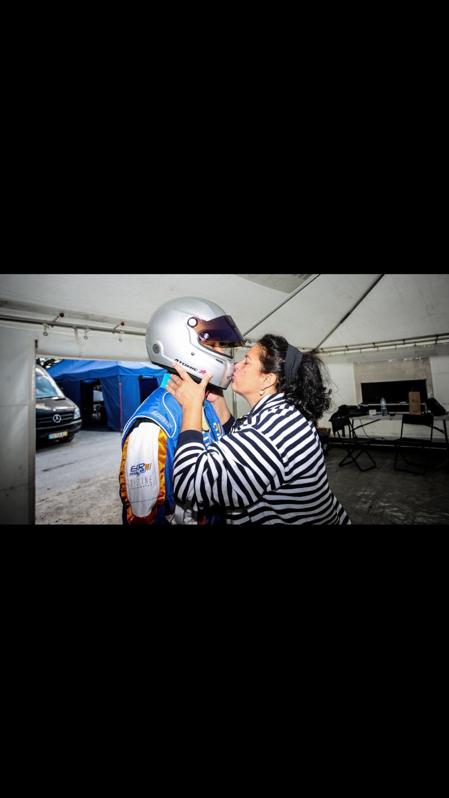 Diego's mother kissing his helmet before the race
