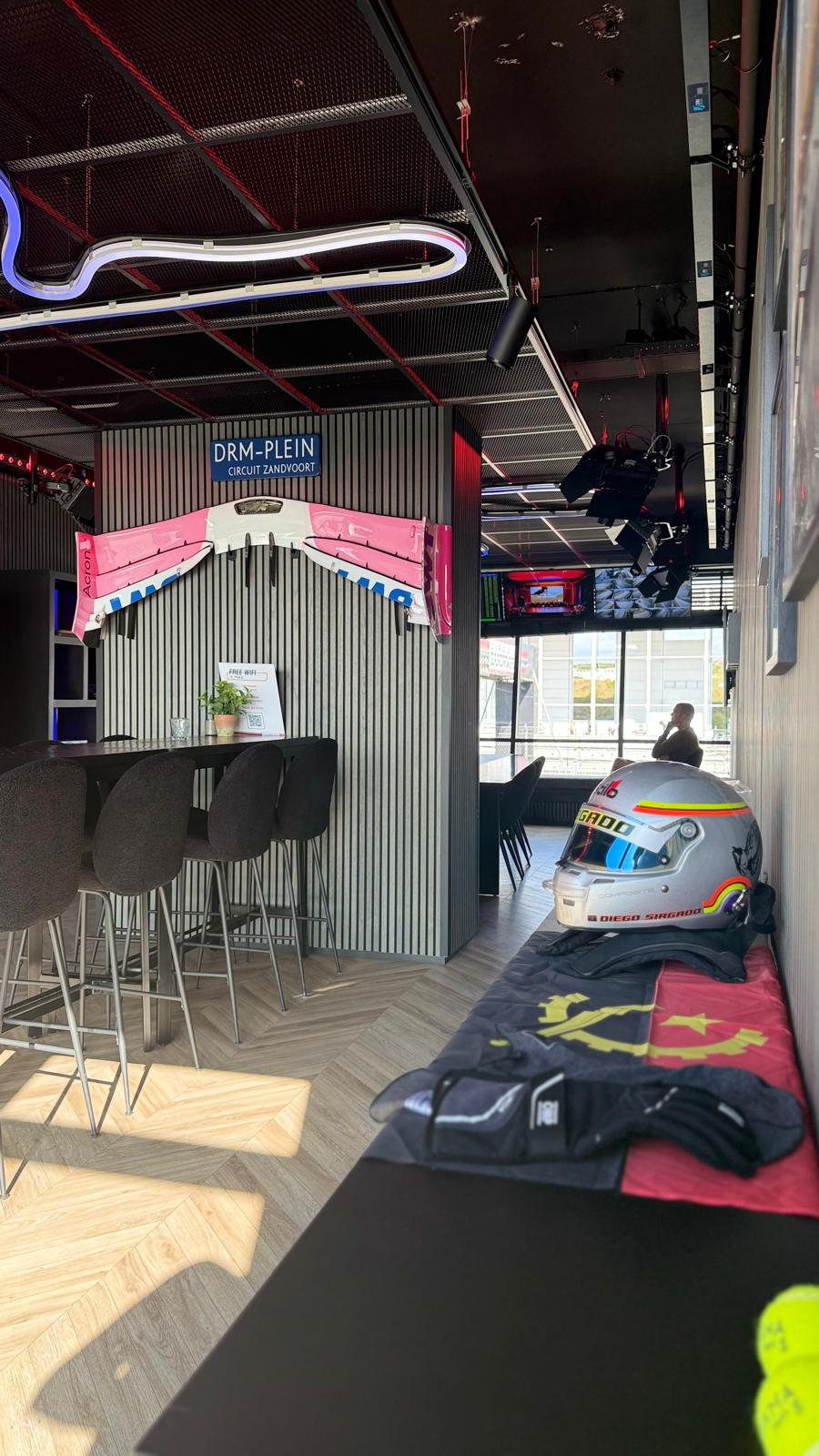 Diego Sirgado's racing helmet and Angola flag displayed inside the private VIP lounge